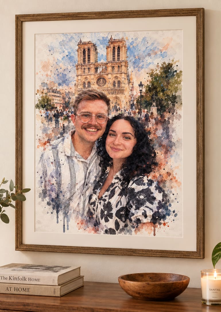 A watercolor painting of a couple in front of Notre-Dame, hanging framed above a console in a warm living room